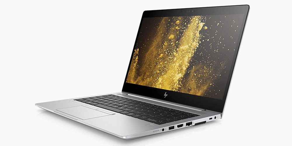 A silver HP laptop with a black and gold screen saver 