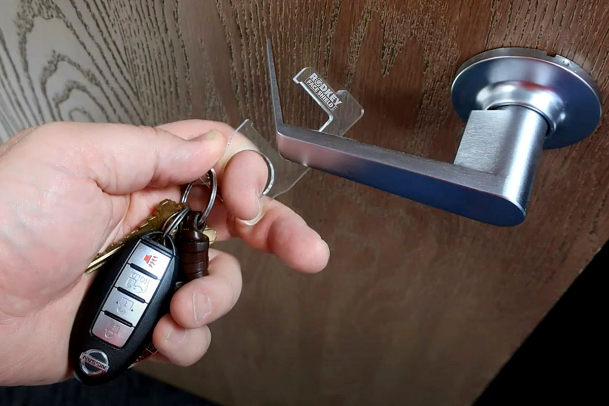 A person opening a door with a keychain. 