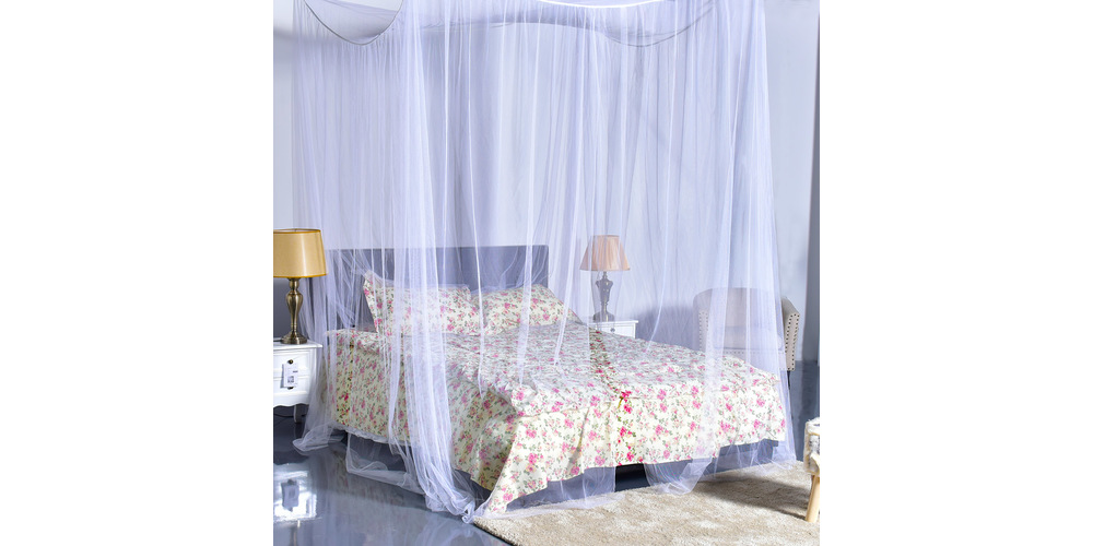 A bedroom with a mosquito net 